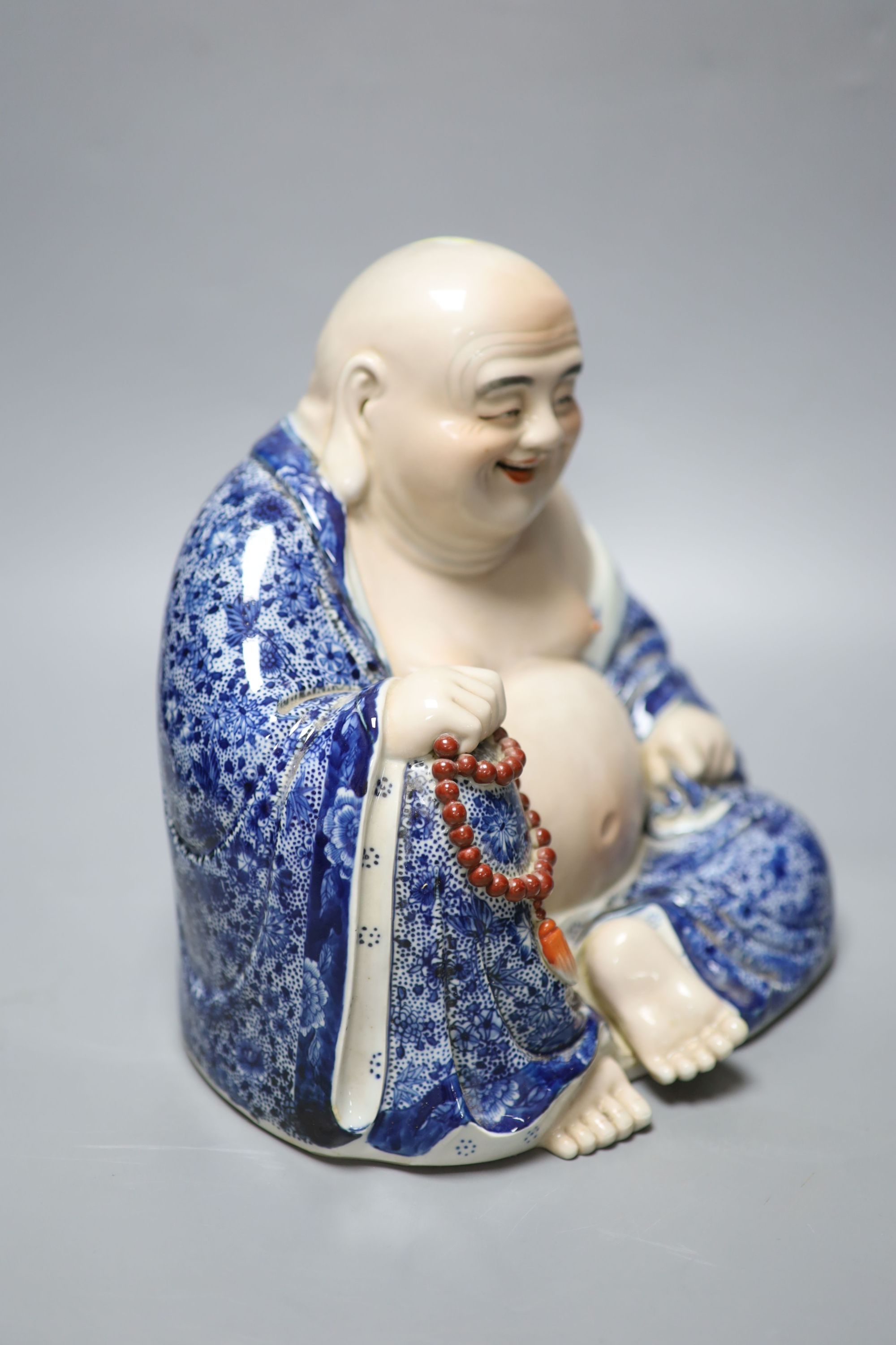 A Chinese porcelain figure of Budai, height 26cm